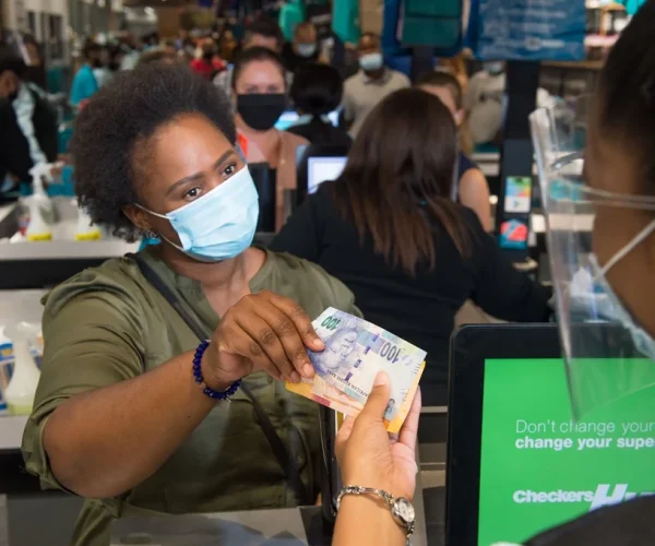 Woman withdrawing money at the supermarket till thanks to PayPulse