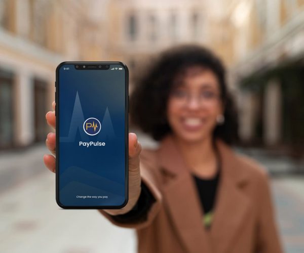 Women holding up her phone with the PayPulse logo showing - PayPulse